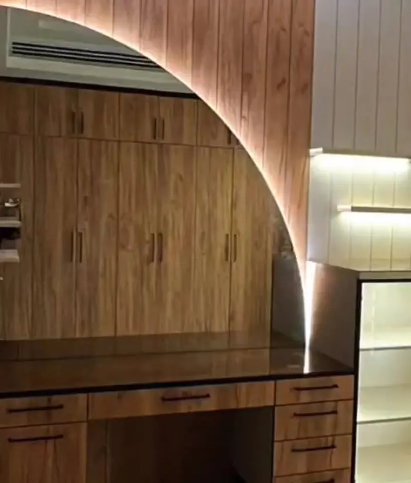 Curved wood-veneer arch with built-in lighting