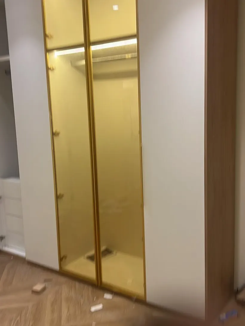 Close-up of a gold-trimmed glass wardrobe door
