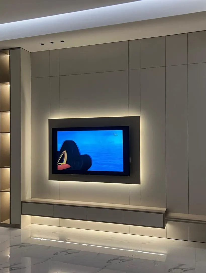 Installed TV wall with backlit shelving niche